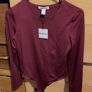 The color is burgundy and never used has tags on , marital is silk